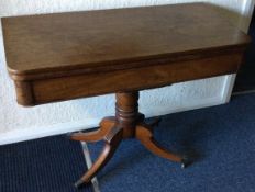 A Victorian hinged top card table on four sweeping supports.