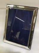 A large rectangular silver picture frame with velvet back.