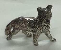 A silver plated figure of an dog.
