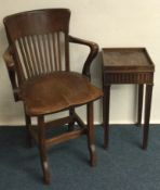A small oak office chair together with a pedestal.