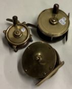 Three antique brass fly fishing reels.