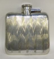 A heavy engine turned silver hip flask with hinged top.