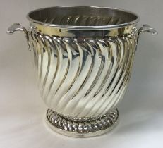 A novelty silver two handled ice bucket of fluted design.