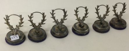 A set of six silver menu holders decorated with hunting scenes.