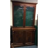 A good tall Victorian glazed bookcase with scroll decoration.