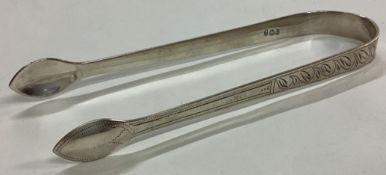 A heavy pair of Provincial Georgian silver feather edge sugar tongs.