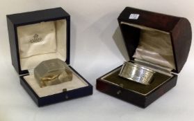 Two cased silver napkin rings.