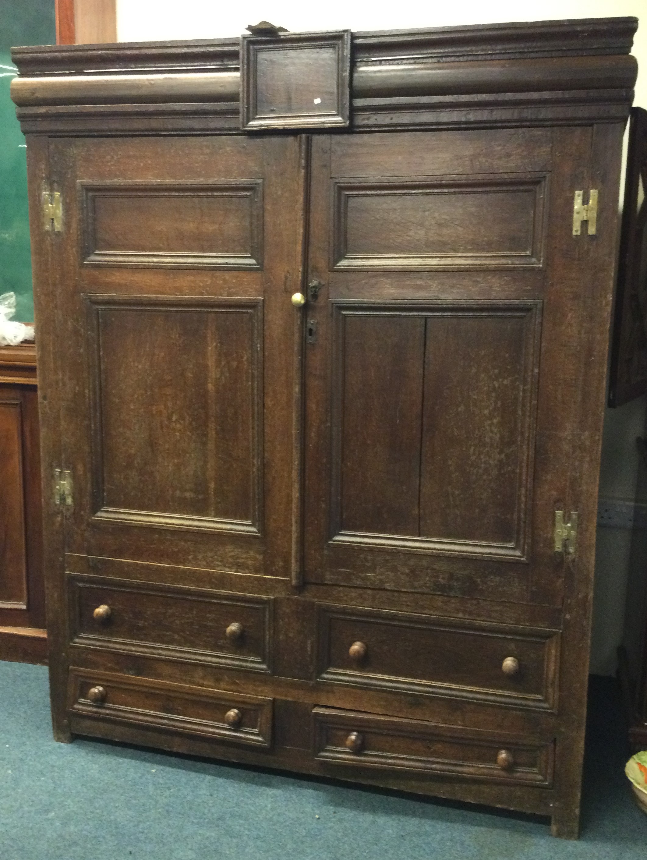 A large Georgian oak housekeepers cupboard with four drawers to base.