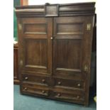 A large Georgian oak housekeepers cupboard with four drawers to base.