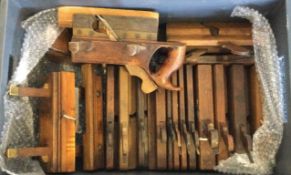 A large collection of old wooden moulding planes.