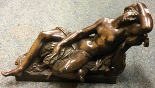 AFTER GIAMBOLOGNA: A bronze group of the sleeping nymph in rich brown patina.