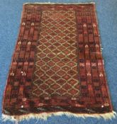 An old tapestry rug in red ground. Approx. 86 cms x 140 cms.