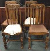 A set of four oak dining chairs.