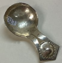 An Arts and Crafts silver caddy spoon with hammered handle.