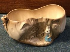 SYLVAC: A vintage beige pottery planter with rabbit in blue dress.