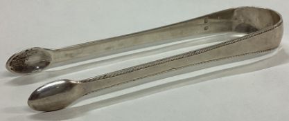 A George III pair of silver sugar tongs with bead pattern.