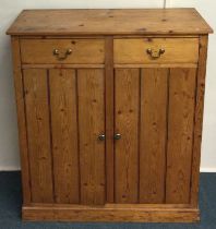 A good stripped pine two door cupboard. Est. £30 -