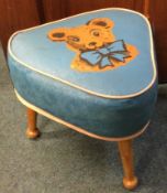 A vintage 1950s / 60s Sherborne triangular child's stool with wooden legs and teddy bear design.