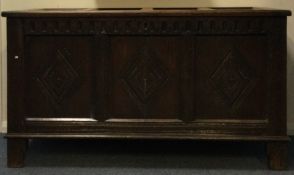 A good Georgian oak coffer with carved front and hinged top lid.