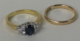 A sapphire and diamond seven stone ring set in 18 carat gold mount together with a wedding band.