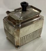 A heavy Victorian silver tea caddy of fluted design.
