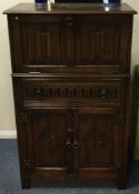 A good carved oak music cabinet. Est. £30 - £50.