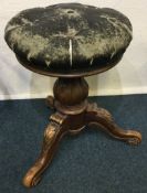 A Victorian stool with a leather top.