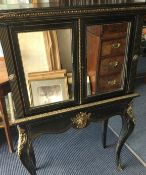A good quality Victorian ebonised pier cabinet with brass ormolu mounts to mirrored front.