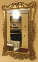 A good Antique gilt frame mirror of shaped form.