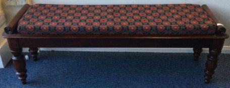 A mahogany hall bench with scroll decoration.