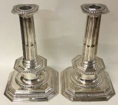 A fine pair of of Queen Anne style cast silver candlesticks.