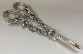 A novelty pair of silver grape scissors cast with foxes and vines.