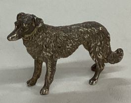 A silver figure of a dog.