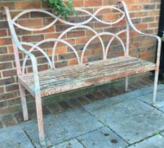An unusual steel garden bench in pink ground.