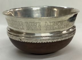 An Arts and Crafts silver and wooden bowl. Inscribed MISEREMINI MEI SALTEM AMICI MEI.