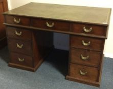 A fine quality Georgian mahogany twin pedestal desk with leather top and brass handles.
