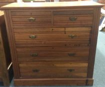 A satinwood five drawer chest.
