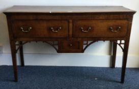 A good early oak three drawer sideboard with brass handles.