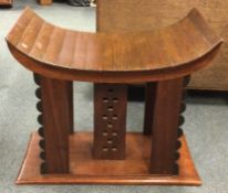 An unusual good quality Tibetan style stool of shaped form on rectangular mount.