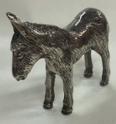 A silver plated figure of a donkey.