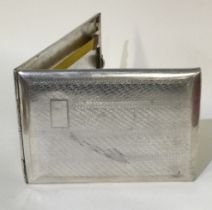 A heavy Continental silver cigarette case with engraved decoration.