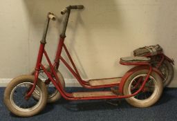 A pair of retro red painted scooters.