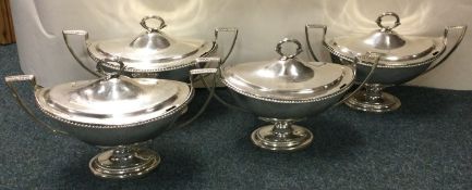 A fine set of four Georgian silver sauce tureens.