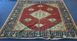 A large Antique rug decorated in bright colours with central medallion.