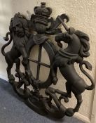 A massive 20th Century cast iron coat of arms mounted with a lion and a unicorn with scroll decorati