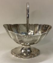 EXETER: An engraved Victorian silver swing handled basket.