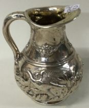 A fine chased Victorian silver jug embossed with birds.