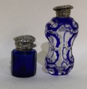 Two silver mounted blue glass scent bottles.