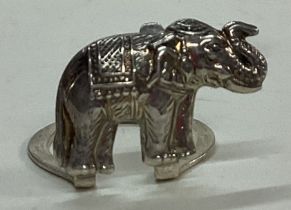 A silver menu holder in the form of an elephant.