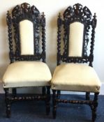 A good pair of carved oak hall chairs.